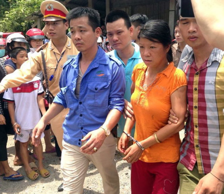 Nghi phạm Nguyễn Thị Hán được dẫn giải lên xe để đưa về trụ sở Công an tỉnh Yên Bái